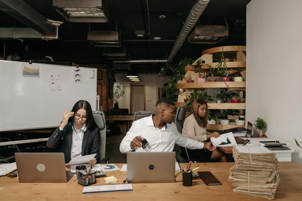 man and women sitting at table checking on business papers